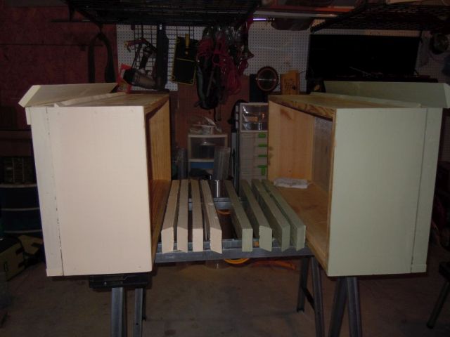 Two horizontal hive boxes and legs set out for painting