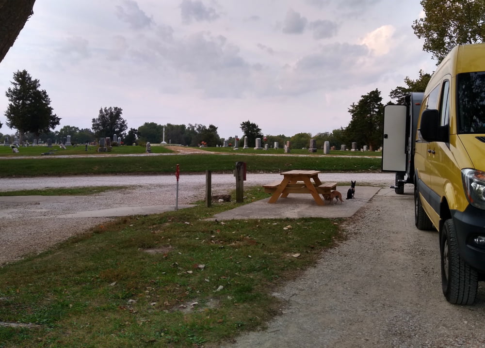 Van parked at Shoemaker's RV Park - cemetary in background