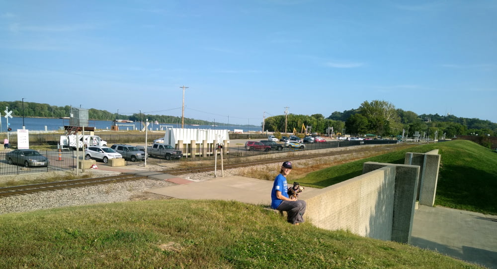 Sue sitting beside levee gate at Hannibal, MO