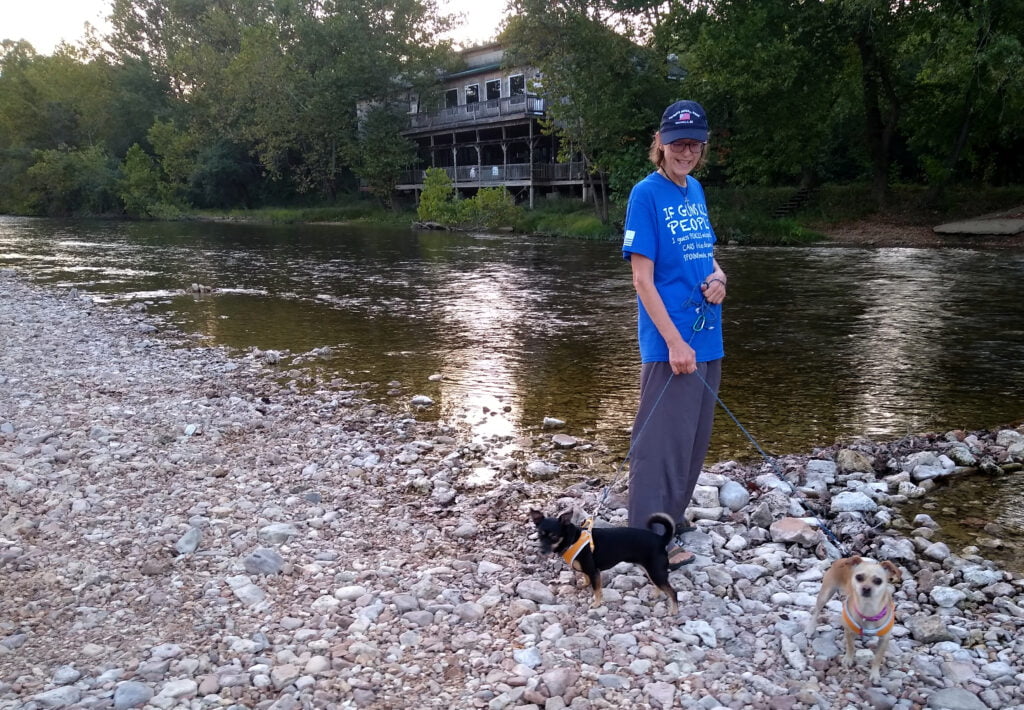 Sue and doggies strolling along the Jack's Fork River at day's end